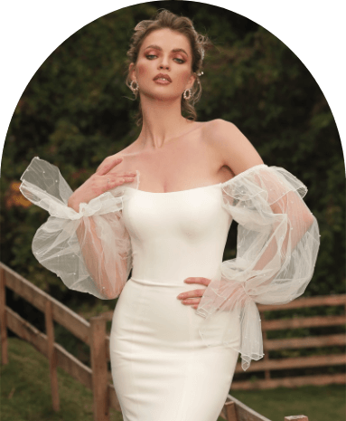 Model wearing a white gown by Chic Nostalgia. Mobile image
