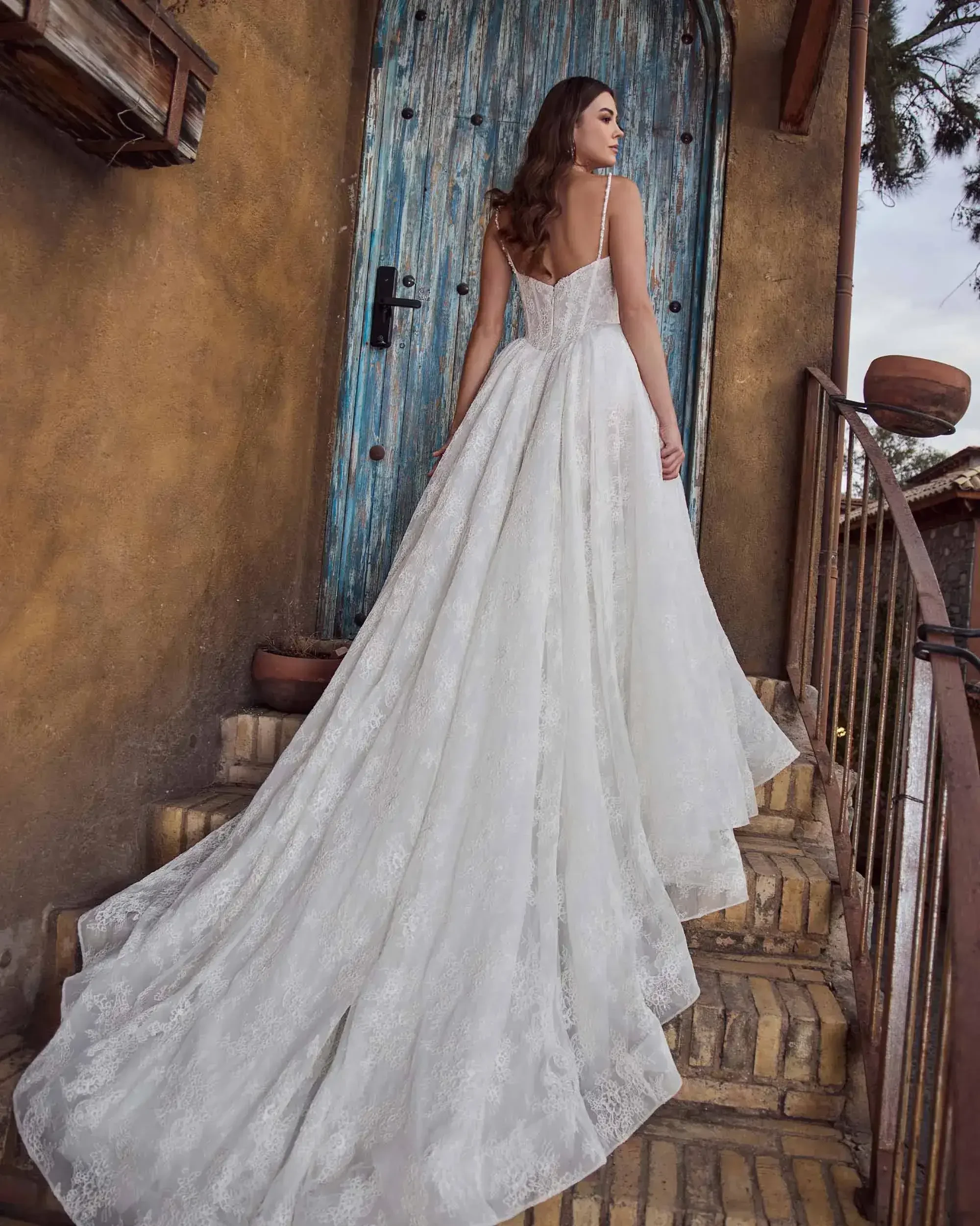 model is wearing a strapless lace ball gown wedding gown