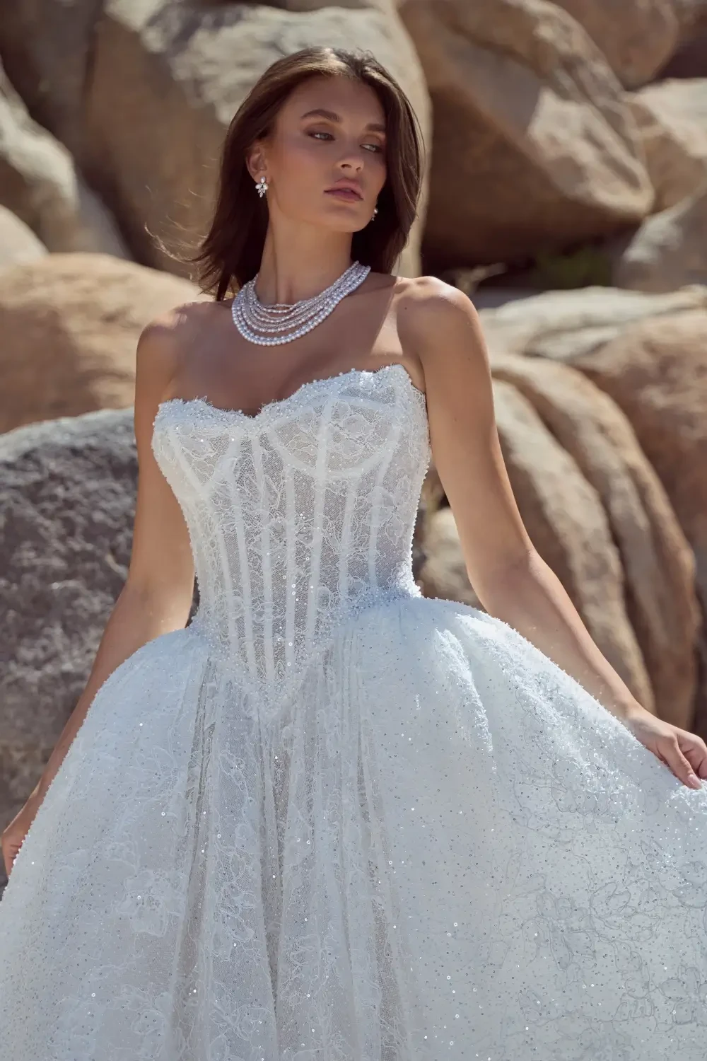 model is wearing a strapless ball gown