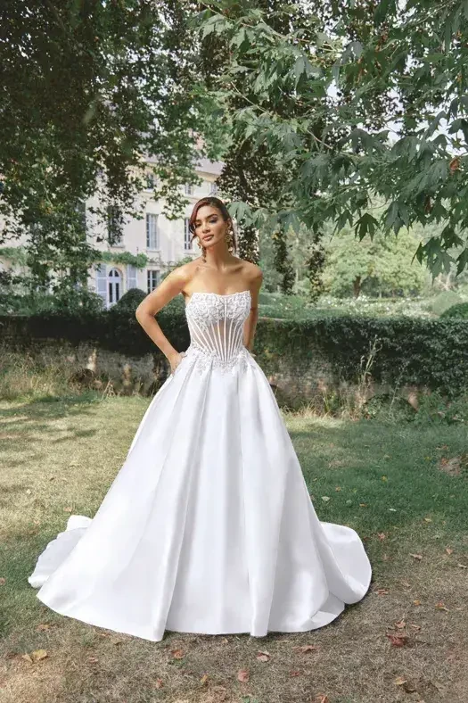 model is wearing a strapless ball gown wedding dress