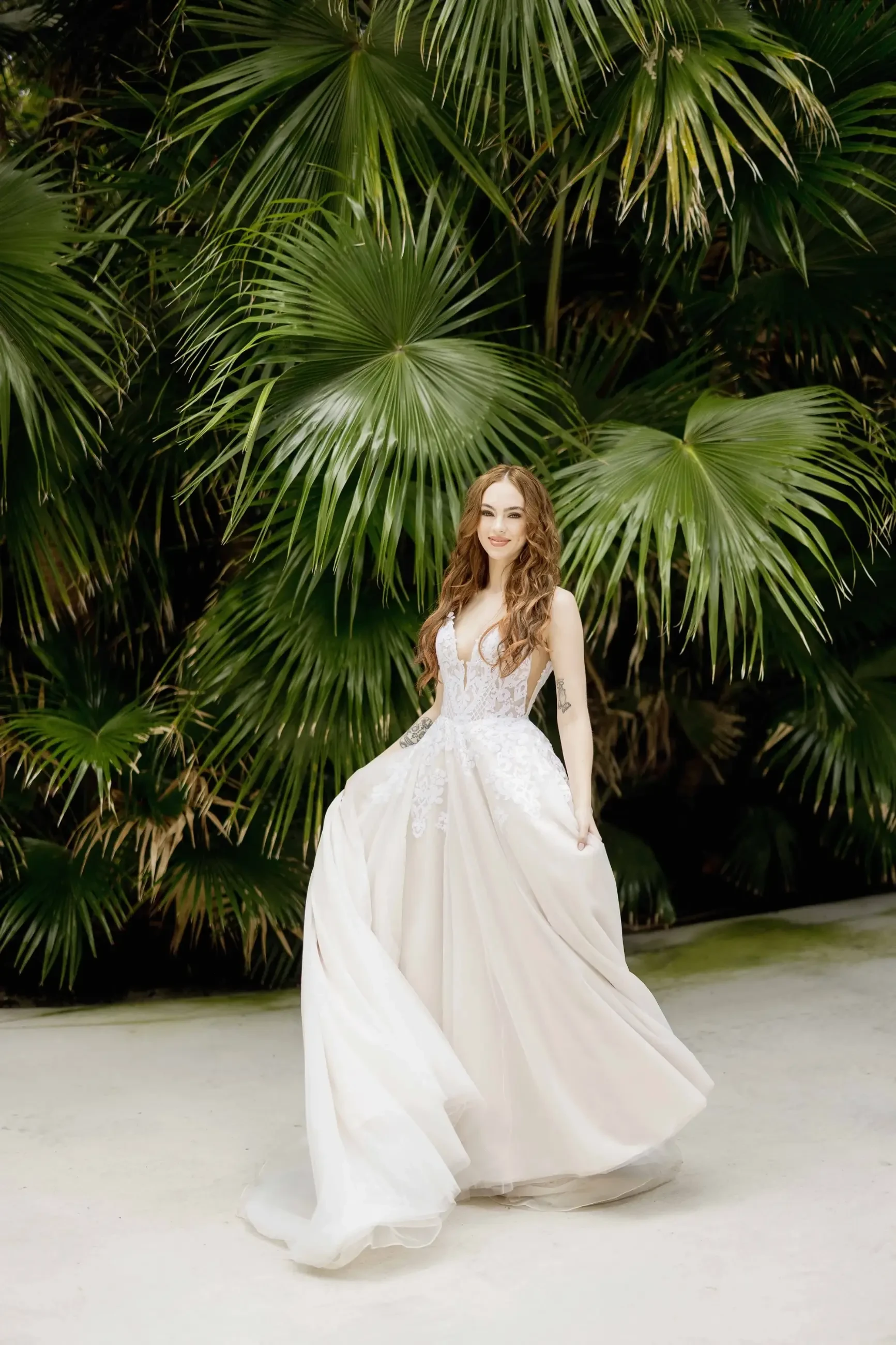 model is wearing a sleeveless a-line bridal gown
