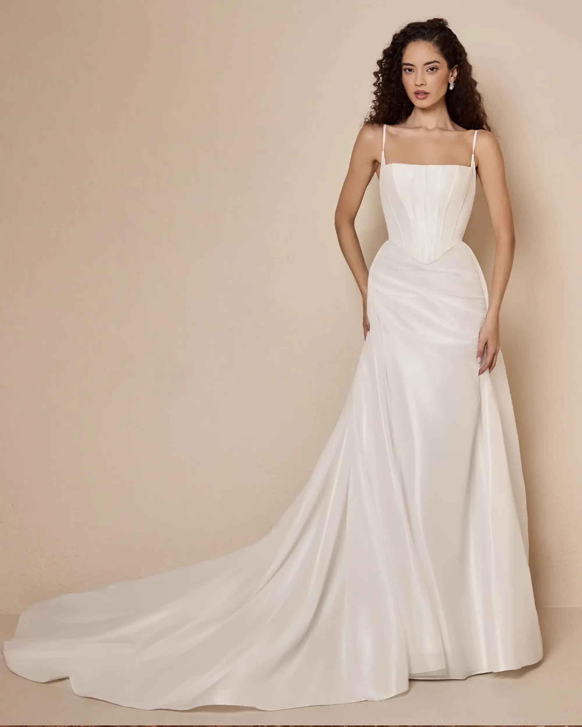 model is wearing a sleeveless corseted wedding dress