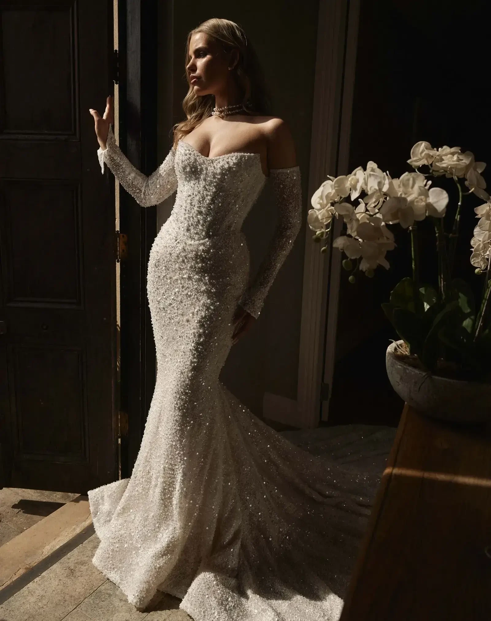 Model wearing a white gown by Blanche Bridal.