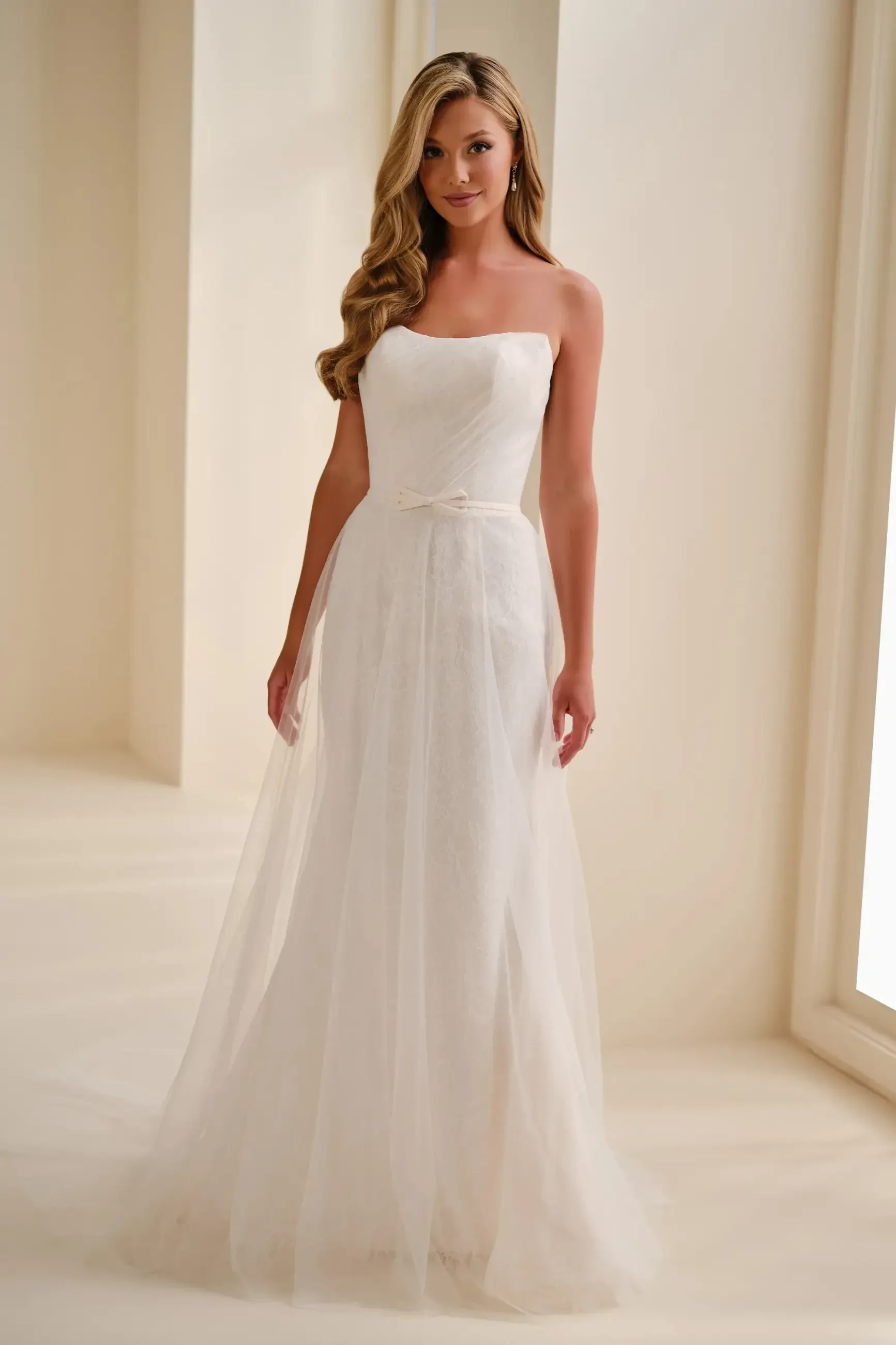 model is wearing a strapless a-line bridal gown