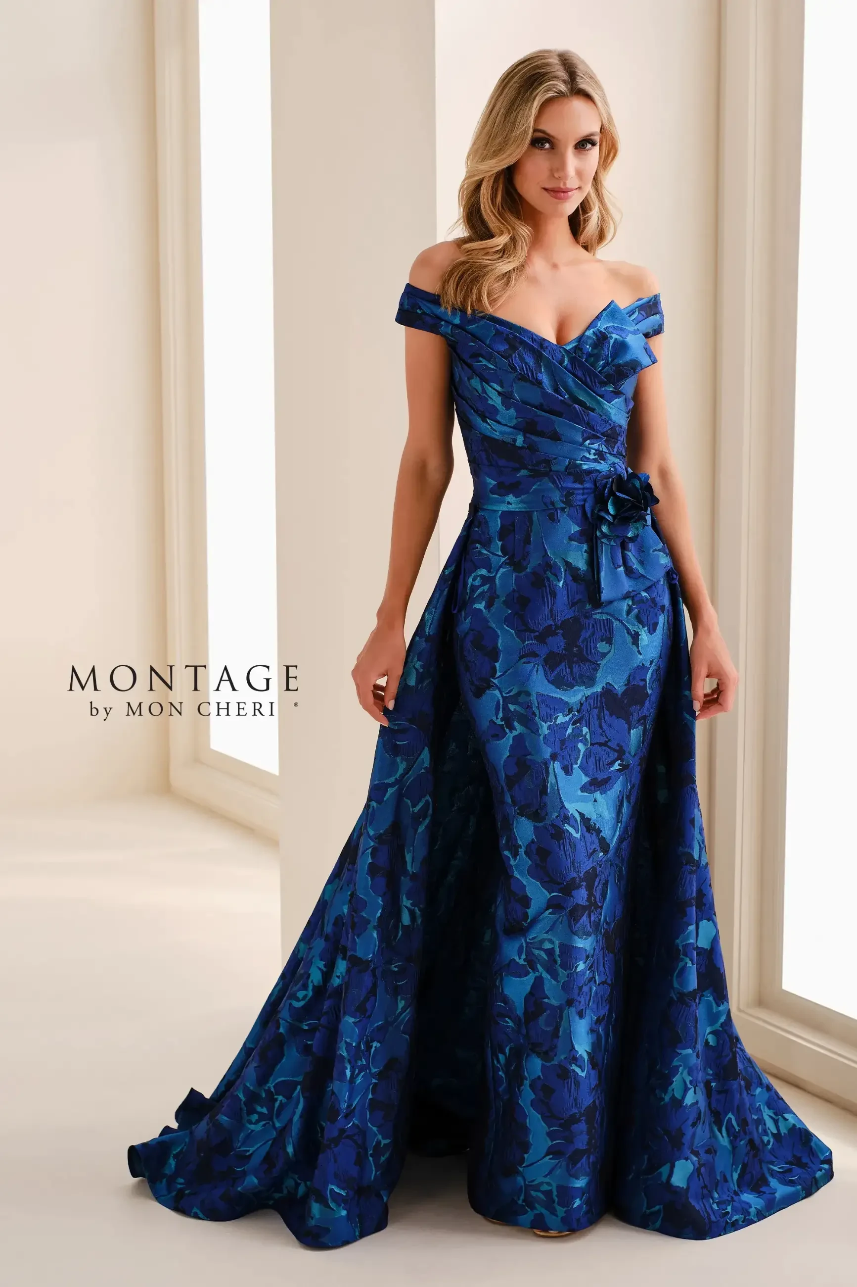 model is wearing an off the shoulder blue mothers dress