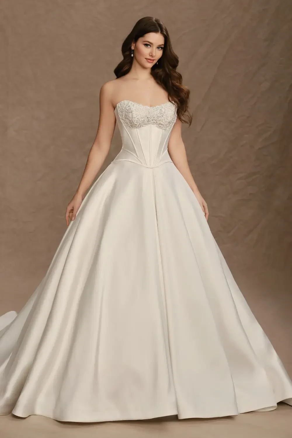 A woman in a strapless, ivory wedding gown with a beaded bodice and a flowing skirt.